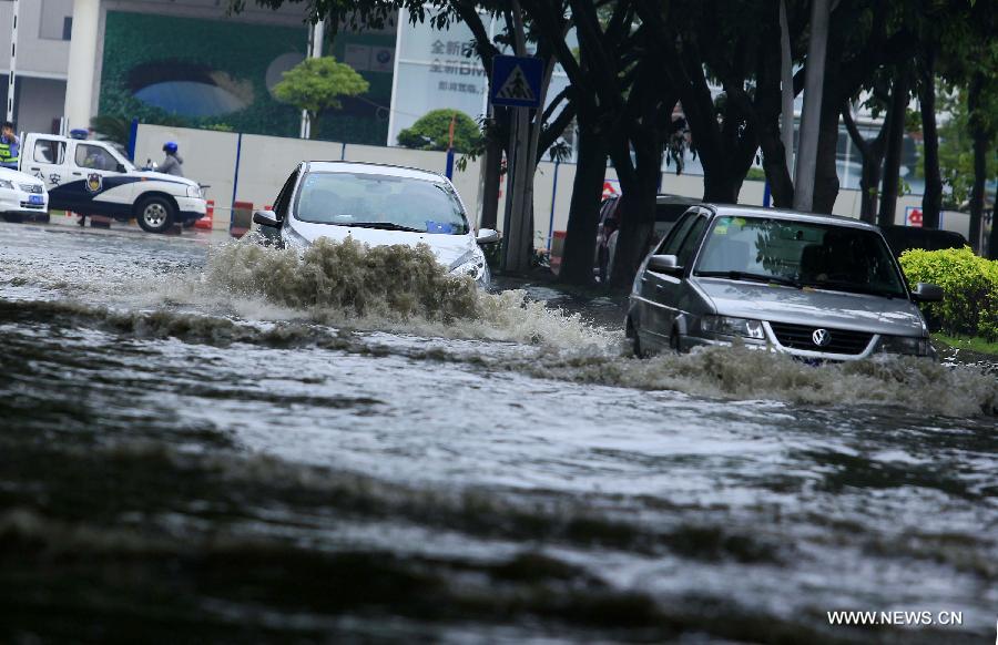 Cars wade through a flooded road in Jinjiang City, southeast China's Fujian Province, May 16, 2013. A torrential rainfall hit the city overnight, flooding many roads in the city. (Xinhua)