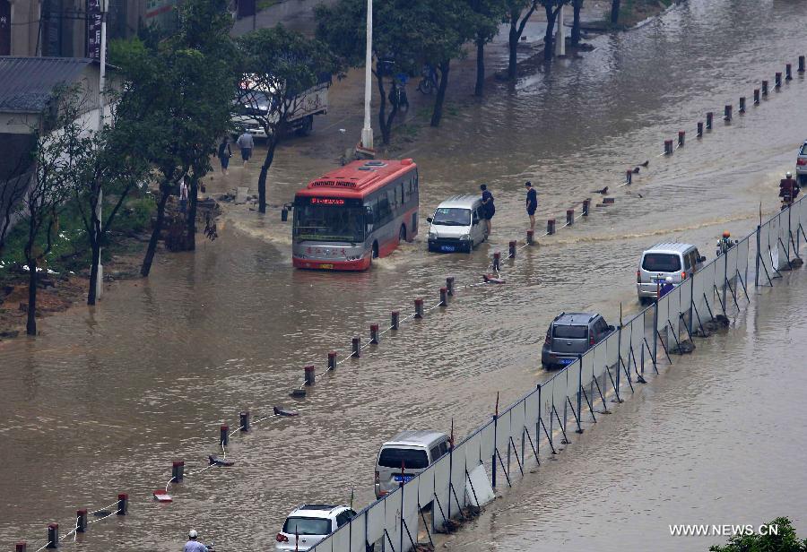 Vehicles wade through a flooded road in Jinjiang City, southeast China's Fujian Province, May 16, 2013. A torrential rainfall hit the city overnight, flooding many roads in the city. (Xinhua)