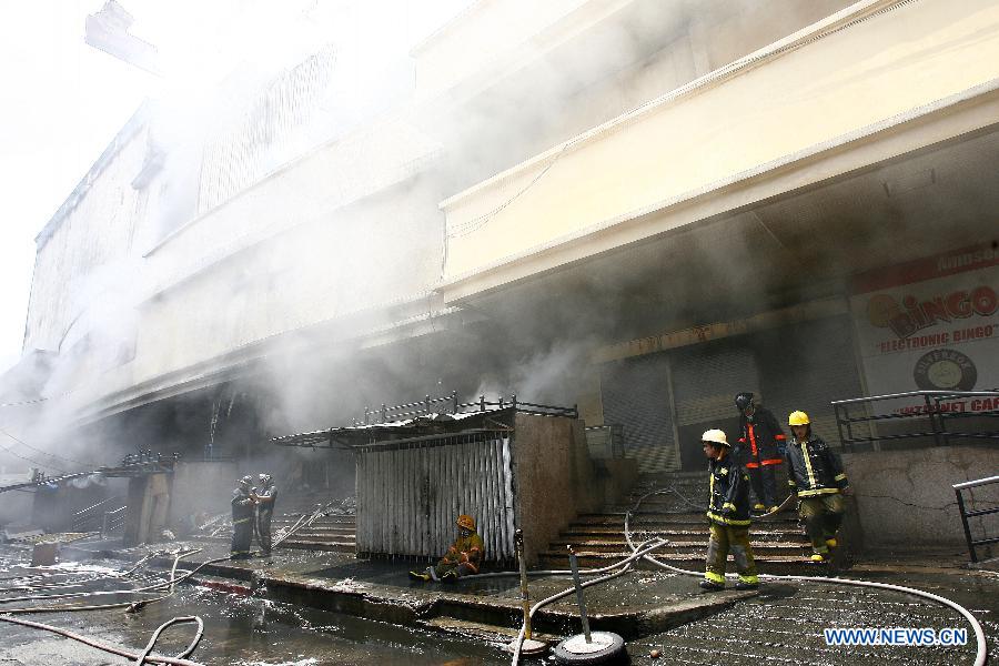 Firefighters work at the fire accident site in Manila, the Philippines, May 16, 2013. Two people were rescued from the fire, as firefighters estimate the fire may last for two days. (Xinhua/Rouelle Umali) 