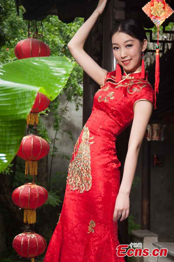 A contestant of the 2013 Miss Tourism International poses for photos in evening dress in Xitang, an ancient town in East China's Zhejiang Province, May 15, 2013. (CNS/Qian Xingqiang)