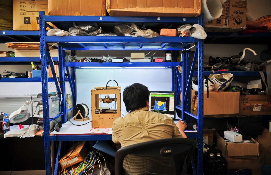 Han Bing adjusts his handmade 3D printer at home in Tianjin Municipality, north China, May 16, 2013. Based on the method released on the internet, the 41-year-old by himself made this machine eventually, which costing some 2,000 RMB yuan (325 U.S. dollars) and spending four months. At present, Han's 3D printer could only make simple items designed on the computer, like teapots and whistles. And he hopes his creation could function more powerfully by continuous improvement. (Xinhua/Zhang Chaoqun) 