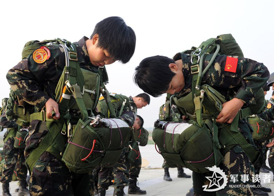 The members from the first female special operation company of the Army of the Chinese People's Liberation Army (PLAA) are in their first parachute landing training on May 14, 2013. (China Military Online/Cheng Jianfeng, Yan Xingxing)