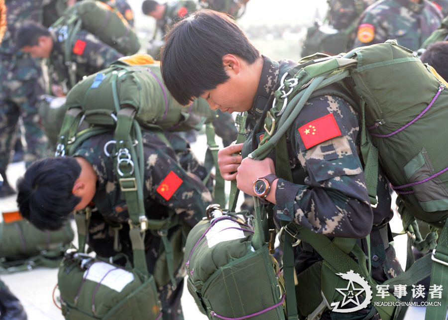 The members from the first female special operation company of the Army of the Chinese People's Liberation Army (PLAA) are in their first parachute landing training on May 14, 2013. (China Military Online/Cheng Jianfeng, Yan Xingxing)