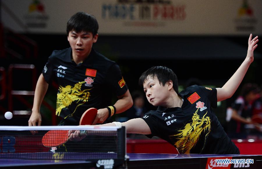 Chen Qi and Hu Limei (R) of China compete during the round of 16 of mixed doubles against Cho Eonroe and Yang Ha-eun of South Korea at the 2013 World Table Tennis Championships in Paris, France on May 16, 2013. Chen Qi and Hu Limei lost 3-4. (Xinhua/Tao Xiyi)