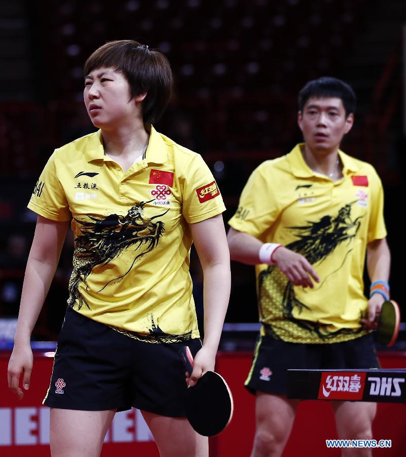 Qiu Yike and Wen Jia (L) of China react during the round of 16 of mixed doubles against Jiang Tianyi and Lee Ho Ching from Hong Kong of China at the 2013 World Table Tennis Championships in Paris, France on May 16, 2013. Qiu Yike and Wen Jia lost 2-4. (Xinhua/Wang Lili)