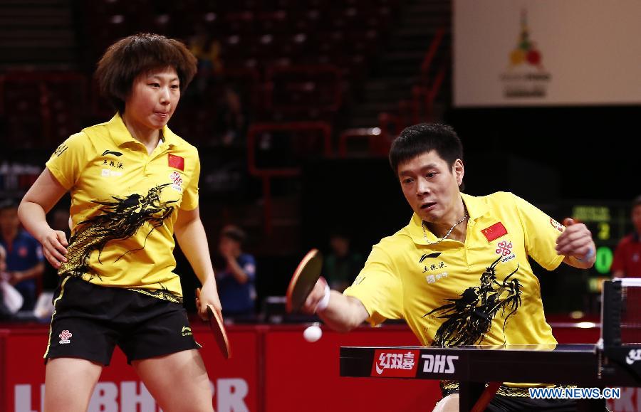 Qiu Yike (R) and Wen Jia of China compete during the round of 16 of mixed doubles against Jiang Tianyi and Lee Ho Ching from Hong Kong of China at the 2013 World Table Tennis Championships in Paris, France on May 16, 2013. Qiu Yike and Wen Jia lost 2-4. (Xinhua/Wang Lili)