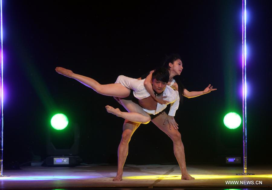 Dancers of China's National Pole Dancing Team perform in "Fairies on the Pole," the world's first pole dance drama, in Tianjin, north China, May 17, 2013. (Xinhua/Liu Dongyue)