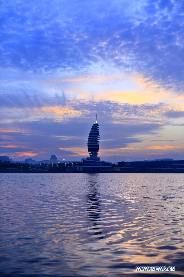 A tower is seen under colorful sunset glow in Rizhao, east China's Shandong Province, May 16, 2013. (Xinhua/Li Xiaolong)  