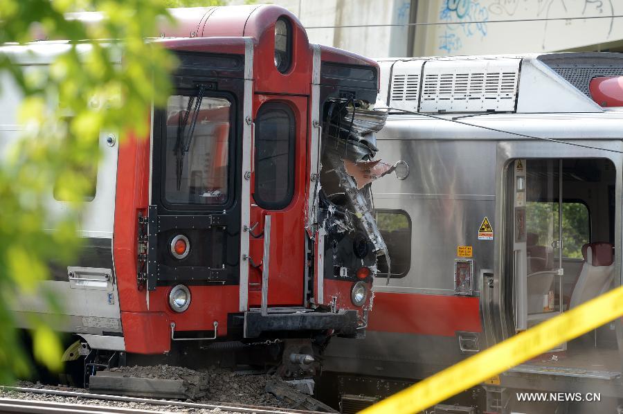 Photo taken on May 18, 2013 shows the scene of a Metro North train collision in Fairfield, Connecticut, the United States. Investigators have begun their probe into the commuter train collision which took place in the U.S. state of Connecticut during Friday evening rush hour, leaving more than 70 injuries, government officials said in a press briefing Saturday. (Xinhua/Wang Lei) 