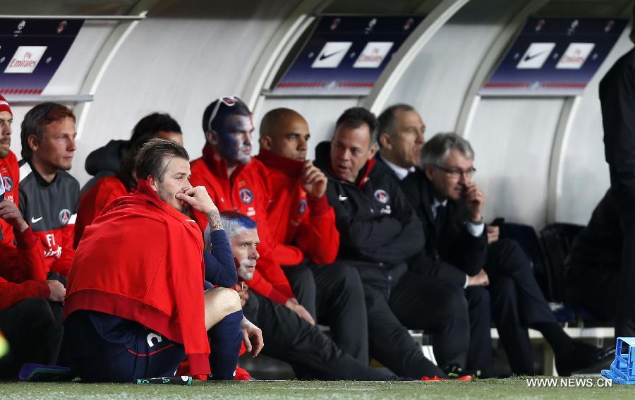 Paris Saint-Germain's English midfielder David Beckham looks pensive sitting on the pitch after he is substituted during a French League 1 football match between Paris St Germain and Brest at Parc des Princes stadium in Paris on May 18, 2013.(Xinhua/Wang Lili)