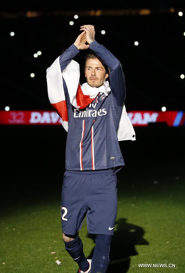 Paris Saint-Germain's English midfielder David Beckham waves to the crowd during the celebration ceremony for winning the French League 1 title after the League 1 football match between Paris St Germain and Brest at Parc des Princes stadium in Paris on May 18, 2013. (Xinhua/Wang Lili)