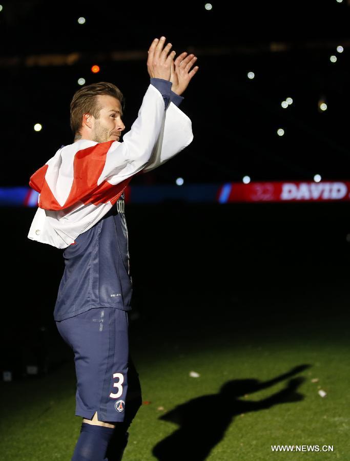 Paris Saint-Germain's English midfielder David Beckham waves to the crowd during the celebration ceremony for winning the French League 1 title after the League 1 football match between Paris St Germain and Brest at Parc des Princes stadium in Paris on May 18, 2013. (Xinhua/Wang Lili)