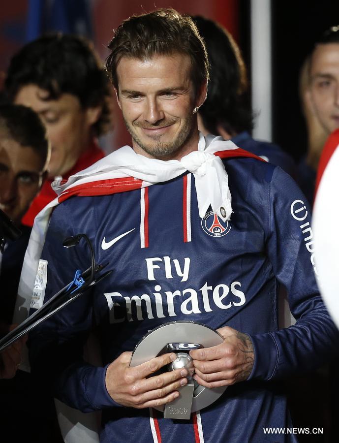 Paris Saint-Germain's English midfielder David Beckham smiles during the celebration ceremony for winning the French League 1 title after the League 1 football match between Paris St Germain and Brest at Parc des Princes stadium in Paris on May 18, 2013. (Xinhua/Wang Lili)