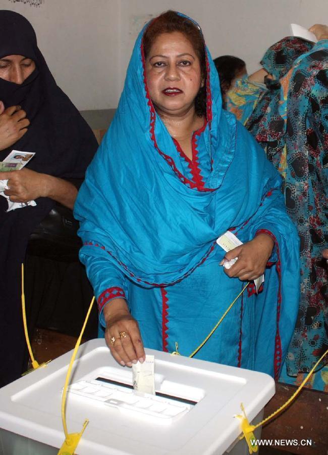 A woman casts her vote at a polling station during the partial re-run election in southern Pakistani port city of Karachi, May 19, 2013. Re-polling on a parliamentary seat started in Pakistan's port city of Karachi Sunday morning following allegations of rigging, officials said. (Xinhua/Arshad) 