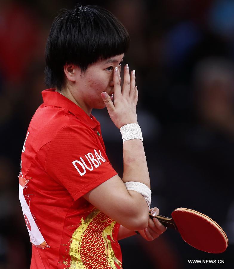 Li Xiaoxia of China reacts during semifinal of women's singles against her teammate Ding Ning at the 2013 World Table Tennis Championships in Paris, France on May 18, 2013. Li won 4-2. (Xinhua/Wang Lili)