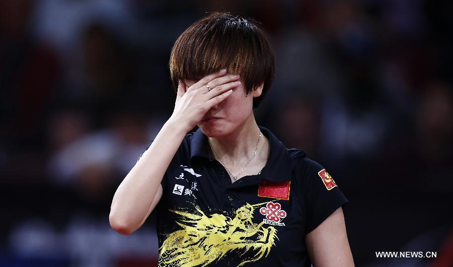 Ding Ning of China reacts during semifinal of women's singles against her teammate Li Xiaoxia at the 2013 World Table Tennis Championships in Paris, France on May 18, 2013. Ding lost 2-4. (Xinhua/Wang Lili)