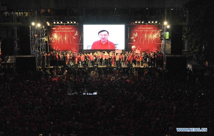 Thailand former prime minister Thaksin Shinawatra speaks to his supporters in screen via "Skype" during a rally in the central business district of Bangkok, Thailand, on May 19, 2013. At least 20,000 supporters of the United Front for Democracy against the Dictatorship (UDD), or the Red shirts, gathered in Bangkok on Sunday to commemorate the third anniversary of the military crackdown on the anti-government protesters. (Xinhua/Gao Jianjun) 