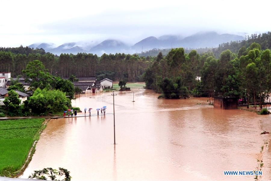 Photo taken on May 19, 2013 shows waterlogged roads and fields in Wenfu Township of Jiaoling County in south China's Guangdong Province. The National Meteorological Center (NMC) Sunday issued a blue alert, the lowest level in a four-color warning system, for rainstorms in the south in the next three days. (Xinhua/Zhong Xiaofeng)