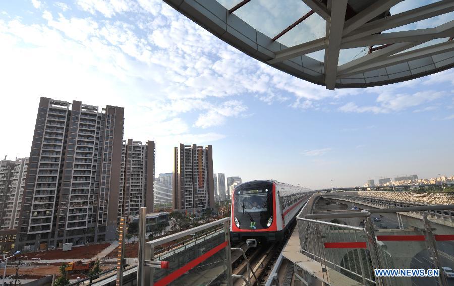 A train of the newly-opened subway line arrives at a station in Kunming, capital of southwest China's Yunnan Province, May 20, 2013. The southern part of the first phase of Kunming subway line 1 and line 2 opened for trial operation on Monday. It's China's first plateau subway. (Xinhua/Lin Yiguang)