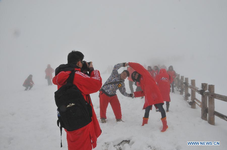 Tourists pose for photo at the Changbai Mountain in northeast China's Jilin Province, May 19, 2013. (Xinhua/Zhang Jian)