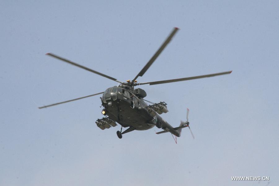 A Peruvian army helicopter participates in a sky diving simulation during the 4th International Exhibition of Technology for Defense and Natural Disaster Prevention (SITDEF, by its Spanish Acronym) in the army headquarters, in San Borja district, department of Lima, Peru, on May 19, 2013. The SITDEF 2013 ran from May 15 to 19. (Xinhua/Luis Camacho)