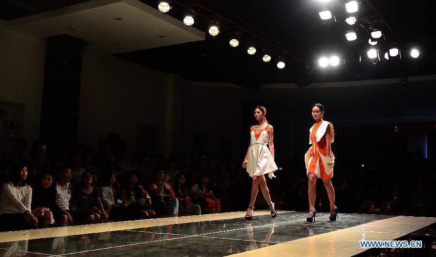 Models present creations designed by graduates of the School of Fashion under the Wuhan Textile University during a fashion show in Wuhan, central China's Hubei Province, May 20, 2013. (Xinhua/Cheng Min)