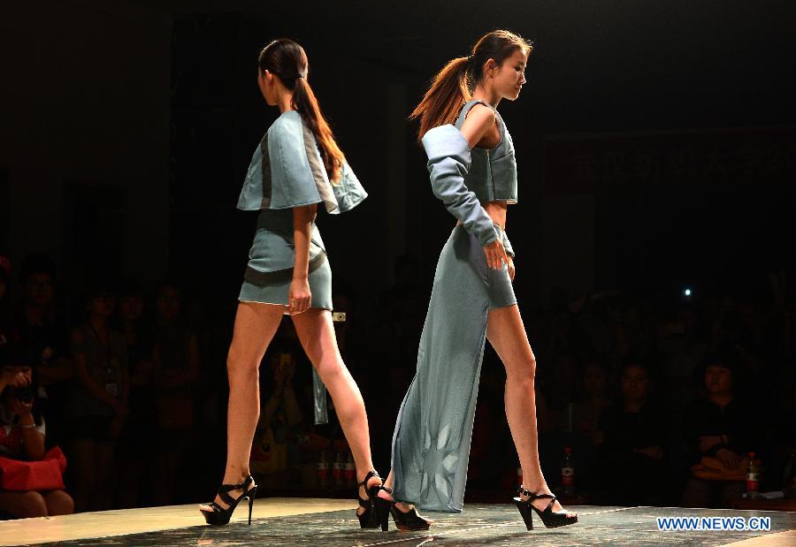 Models present creations designed by graduates of the School of Fashion under the Wuhan Textile University during a fashion show in Wuhan, central China's Hubei Province, May 20, 2013. (Xinhua/Cheng Min)