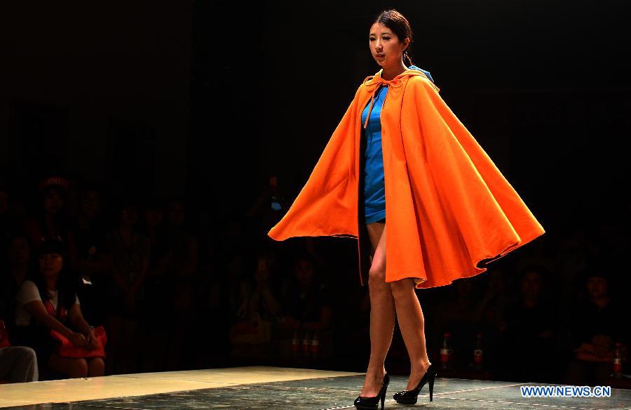 A model presents a creation designed by the graduate of the School of Fashion under the Wuhan Textile University during a fashion show in Wuhan, central China's Hubei Province, May 20, 2013. (Xinhua/Cheng Min)