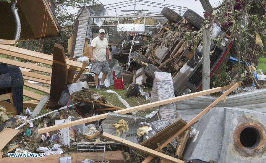 A man peers through the wreckage in Shawnee, Oklahoma, the United States, May 20, 2013. Two men were confirmed dead after tornadoes hit the U.S. state of Oklahoma, officials said Monday. Tornadoes ravaged portions of central Oklahoma on Sunday, according to media reports. (Xinhua/Marcus DiPaola) 