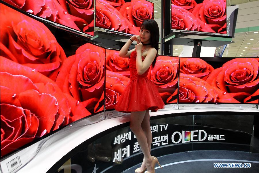 A model of LG Electronics poses during an annual World IT Show at the Seoul's Convention and Exhibition Center (COEX), South Korea, on May 21, 2013. South Korea's largest consumer electronics and technology trade fair kicked off here on Tuesday, showcasing the latest mobile gadgets and telecommunication technologies. (Xinhua/Park Jin-hee)