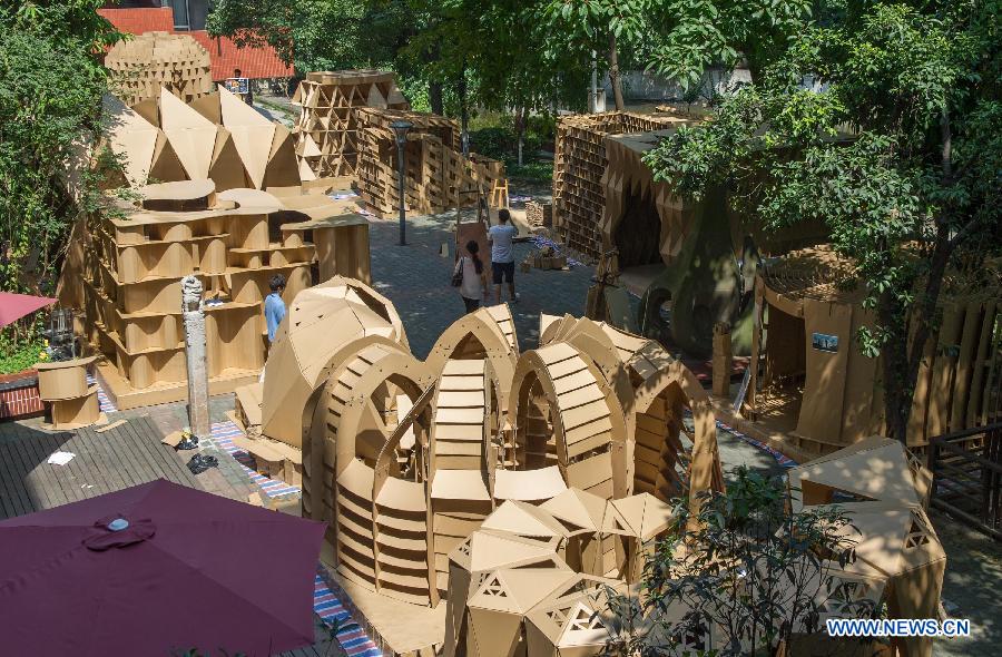 Photo taken on May 21, 2013 shows the paper houses in the Chongqing University, Chongqing, southwest China. Fourteen paper houses, made up with recycled paper by more than 200 freshmen, were displayed in the Faculty of Architecture and Urban Planning of the university on Tuesday. (Xinhua/Chen Cheng)