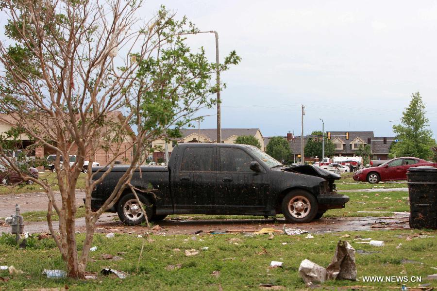 A destroyed car is seen in a neighborhood of Moore, Oklahoma, May 21, 2013, one day after a tornado moved through the area. A powerful tornado attacked on Monday afternoon the southern suburbs of the Oklahoma City, capital of the U.S. state of Oklahoma, killing at least 24 people, including 9 children. (Xinhua/Song Qiong) 