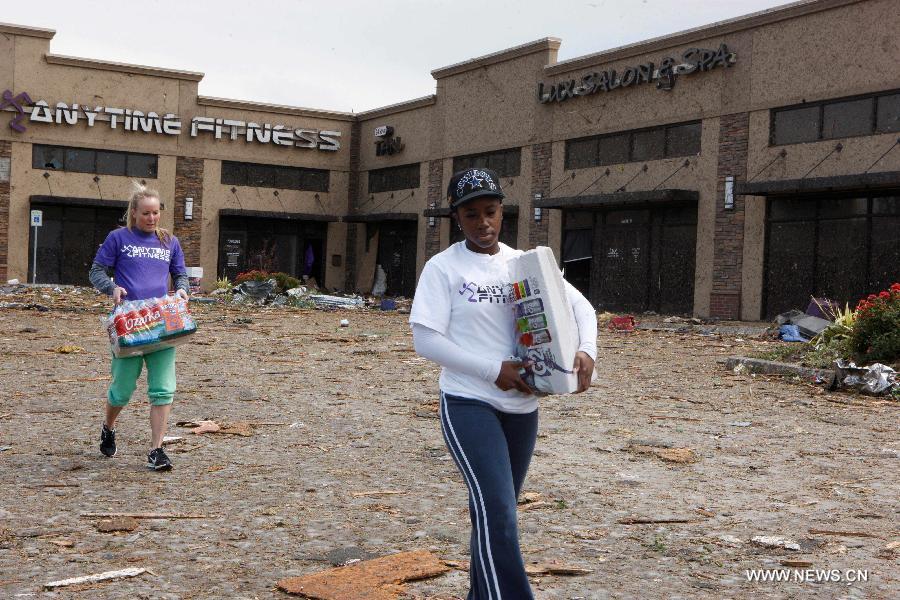 Residents begin cleanup of a destroyed fitness center in Moore, Oklahoma, May 21, 2013, one day after a tornado moved through the area. A powerful tornado attacked on Monday afternoon the southern suburbs of the Oklahoma City, capital of the U.S. state of Oklahoma, killing at least 24 people, including 9 children. (Xinhua/Song Qiong) 