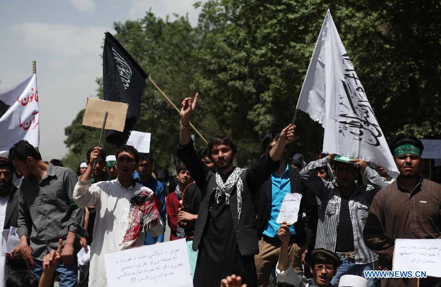 Afghan university students chant slogans during a protest against the Elimination of Violence against Women (EVAW) law, in Kabul Afghanistan on May 22, 2013. The protesters said parts of the EVAW law, endorsed by Afghan President Hamid Karzai in 2009, are against Islamic teaching. The law has yet to be ratified by the parliament. (Xinhua/Ahmad Massoud)