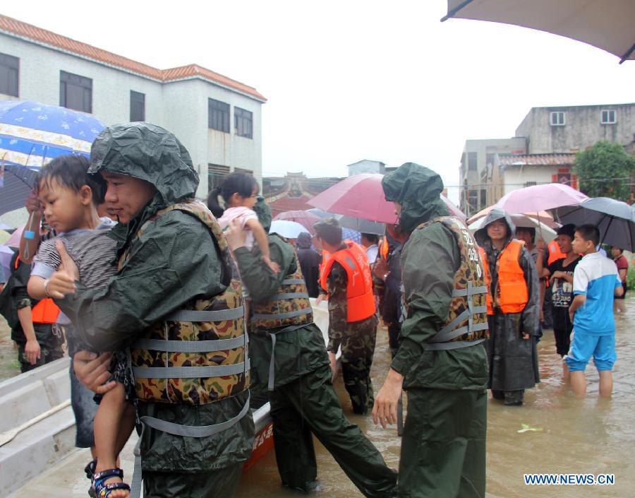 Rescuers evacuate children to lifeboats in Yanshi Village of Shanwei City, south China's Guangdong Province, May 22, 2013. A lasting rainstorm in recent days left more than 50 people stranded and some villages flooded in Shanwei City on May 22. (Xinhua/Yang Fan) 