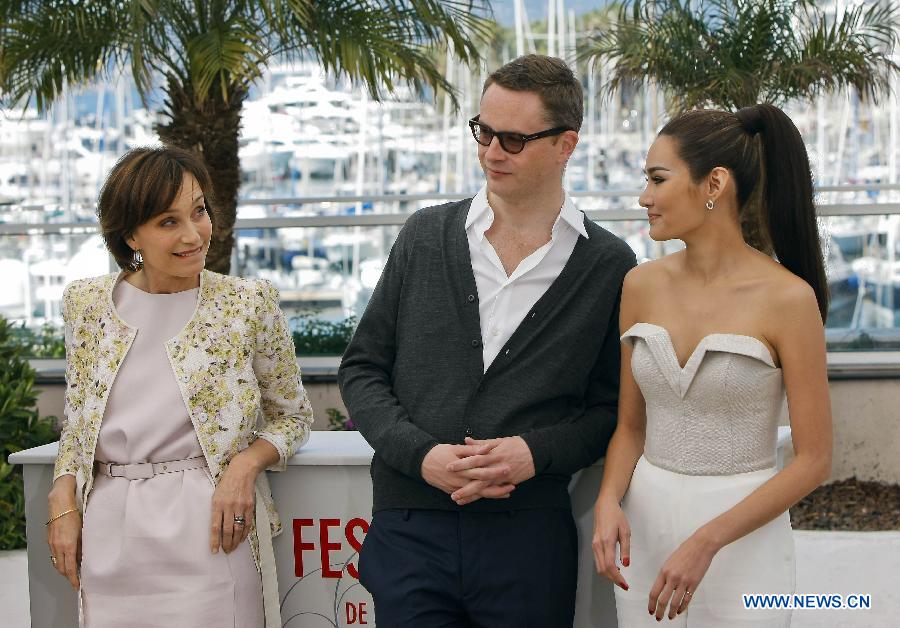 Director Nicolas Winding Refn (C), actress Kristin Scott Thomas (L) and actress Rhatha Phongam pose during the photocall for the film "Only God Forgives" at the 66th edition of the Cannes Film Festival in Cannes, France, on May 22, 2013. (Xinhua/Zhou Lei) 