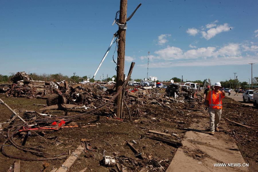 A rescuer works in a tornado-destroyed neighborhood in Moore, Oklahoma, the United States, May 22, 2013. Twenty-four people were killed and 237 others injured when a massive tornado blasted the southern suburbs of Oklahoma City on Monday. (Xinhua/Song Qiong) 