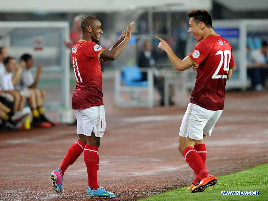 Luis Muriqi (L) of Guangzhou Evergrande celebrates his goal with his teammate Gao Lin during the AFC Champions League round of 16 second leg match against Central Coast Mariners in Guangzhou, capital of south China's Guangdong Province, May 22, 2013. Guangzhou Evergrande won 3-0 and entered the quarterfinals with an aggregate 5-1. (Xinhua/Liu Dawei)