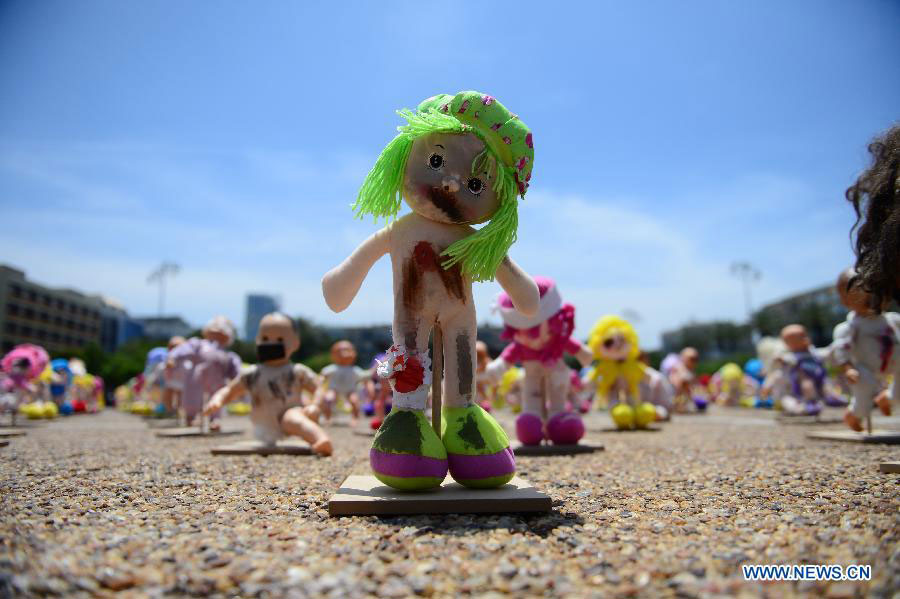 Some "abused" dolls are seen at Rabin Square in Tel Aviv, Israel, on May 23, 2013. Approximately 1,000 dolls, made as if they have been abused, were on a display here to arouse public awareness of child abuse and its long-term effect on those victims. (Xinhua/Yin Dongxun) 