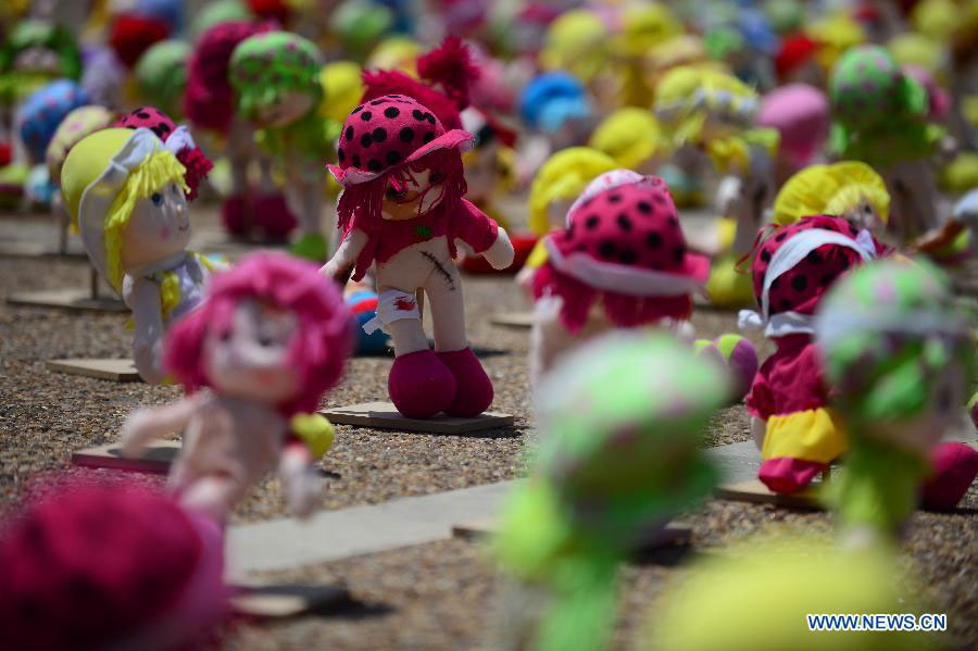 Some "abused" dolls are seen at Rabin Square in Tel Aviv, Israel, on May 23, 2013. AApproximately 1,000 dolls, made as if they have been abused, were on a display here to arouse public awareness of child abuse and its long-term effect on those victims. (Xinhua/Yin Dongxun)