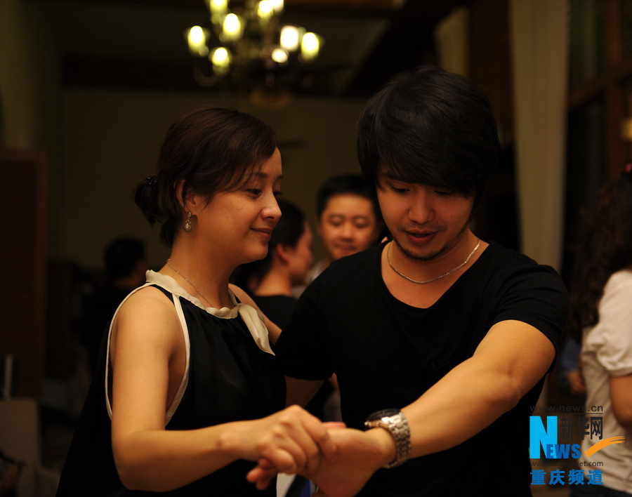 People dance Salsa in a dancing party in Chongqing.