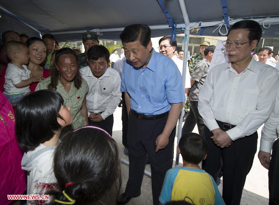 Chinese President Xi Jinping (C) visits quake-affected residents during an inspection tour from May 21 to May 23 in Lushan County, southwest China's Sichuan Province. A quake hit Lushan on April 20, killing at least 196 people. (Xinhua/Huang Jingwen)