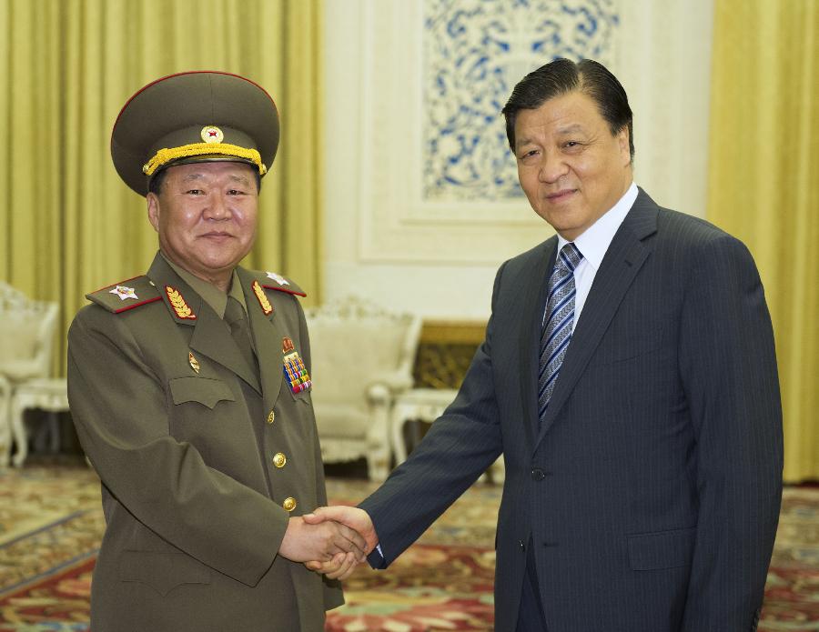Liu Yunshan (R), a member of the Standing Committee of the Political Bureau of the Communist Party of China (CPC) Central Committee, meets with Choe Ryong Hae (L), the special envoy to the leader of the Democratic People's Republic of Korea (DPRK) Kim Jong Un, in Beijing, capital of China, May 23, 2013. Choe Ryong Hae, director of the General Political Bureau of the Korean People's Army and member of the Presidium of the Political Bureau of the the Workers' Party of Korea Central Committee, arrived in Beijing from Pyongyang Wednesday. (Xinhua/Xie Huanchi)
