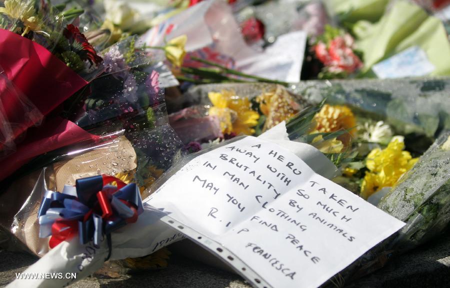 Flowers are seen at the entrance to the Royal Artillery Barracks in Woolwich in southeast London, May 23, 2013. A serving soldier was hacked to death by two attackers wielding knives including a meat cleaver near the Royal Artillery Barracks in Woolwich on Wednesday afternoon. (Xinhua/Bimal Gautam)