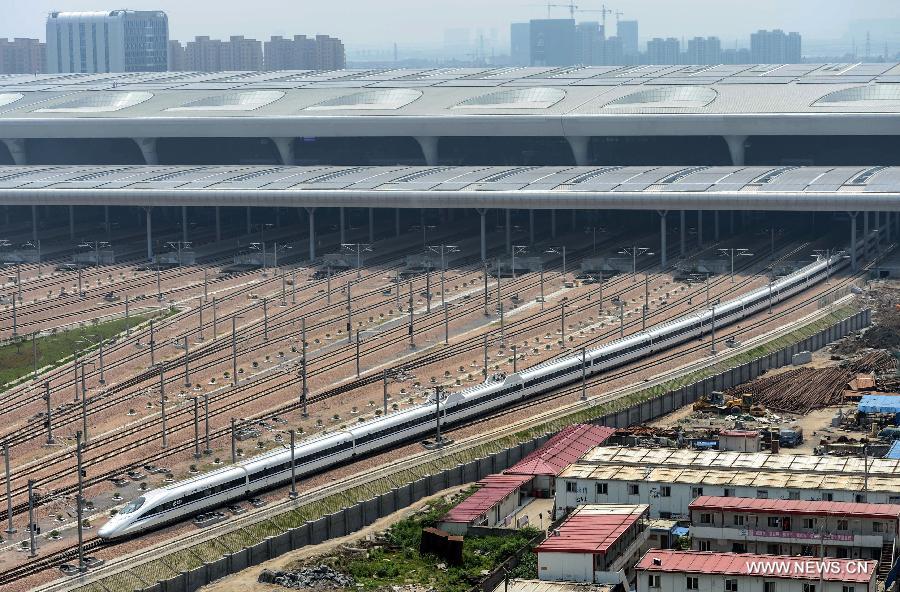 A high-speed train leaves the Hangzhou East Station for Nanjing in Hangzhou, capital of east China's Zhejiang Province, May 24, 2013. High-speed rail lines from Nanjing to Hangzhou and Hangzhou to Ningbo began a month-long trial operations on Friday. (Xinhua/Han Chuanhao) 