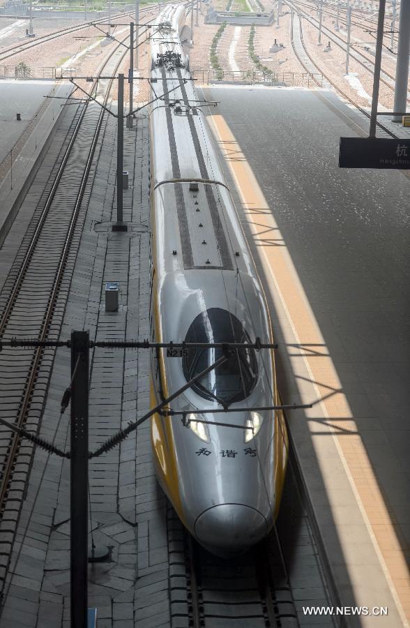 A high-speed train from Ningbo drives into Hangzhou East Station in Hangzhou, capital of east China's Zhejiang Province, May 24, 2013. High-speed rail lines from Nanjing to Hangzhou and Hangzhou to Ningbo began a month-long trial operations on Friday. (Xinhua/Han Chuanhao) 