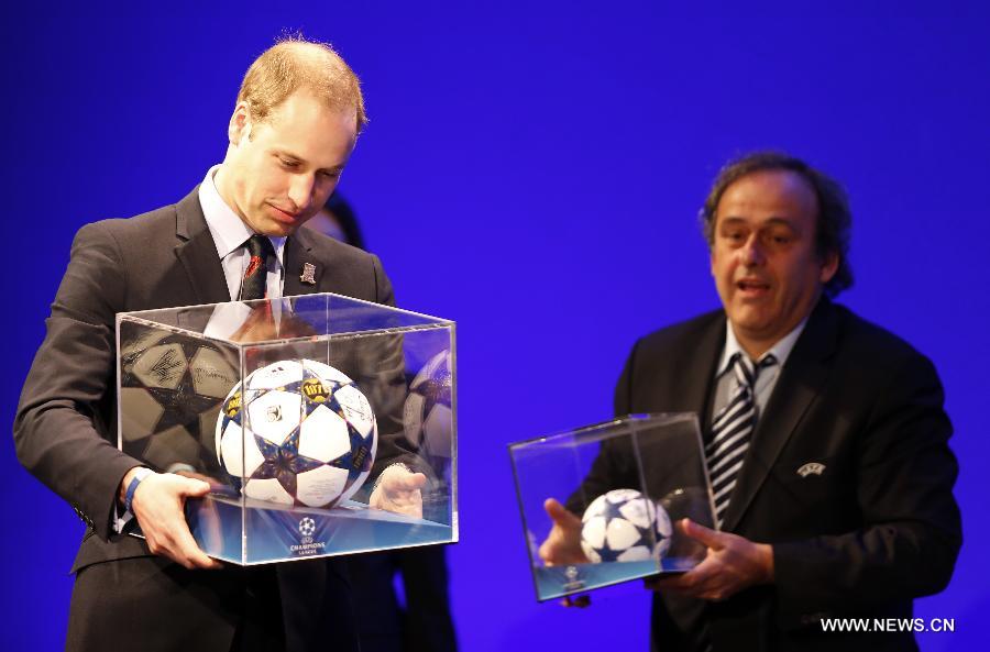 UEFA president Michel Platini (R) presents gifts to Prince William (L), the Duke of Cambridge, during the XXXVII Ordinary UEFA Congress 2013 at Grovesnor House Hotel in London, Britain, on May 24, 2013. (Xinhua/Wang Lili) 