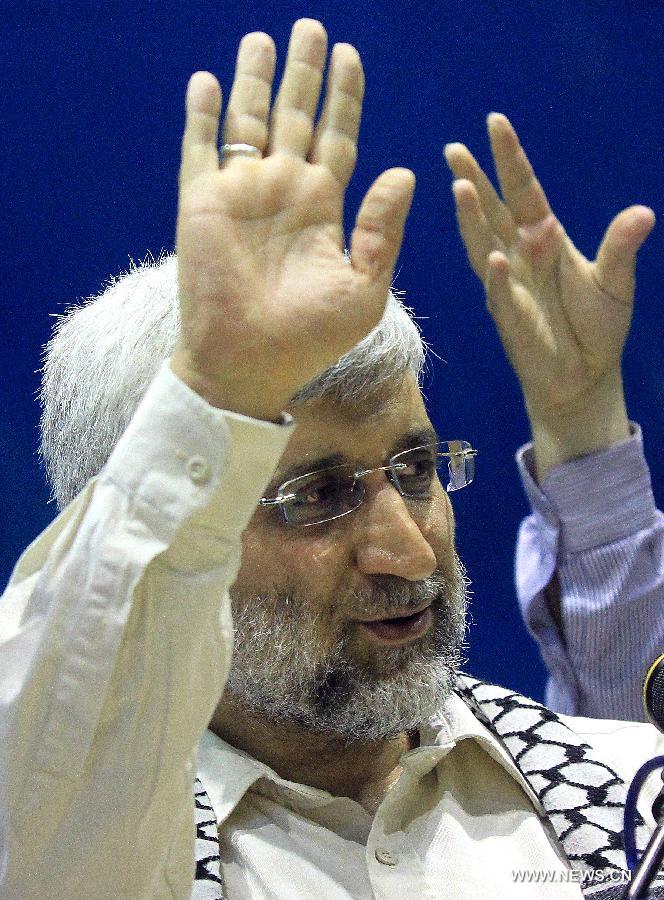Iran's chief nuclear negotiator and presidential candidate Saeed Jalili waves to his supporters during a campaign rally in downtown Tehran, Iran, on May 24, 2013. Iran's Guardian Council of Constitution announced the names of eight eligible candidates for the upcoming presidential election while barring two major political figures from running for presidency. (Xinhua/Ahmad Halabisaz) 