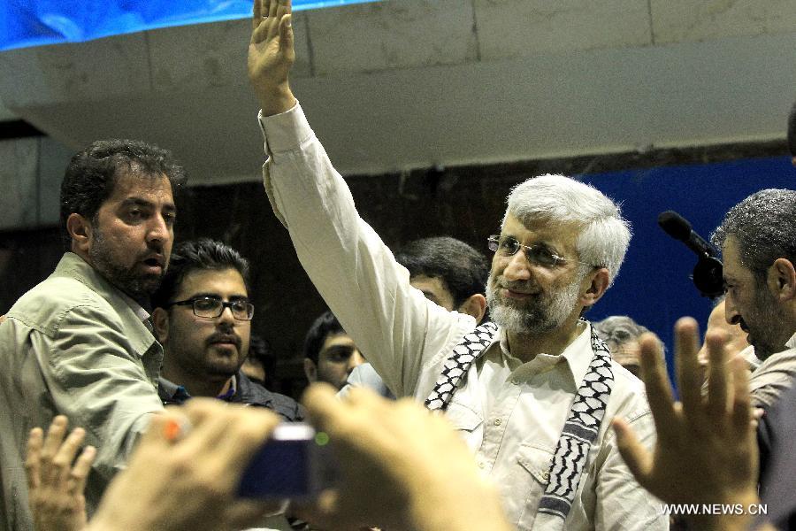 Iran's chief nuclear negotiator and presidential candidate Saeed Jalili waves to his supporters during a campaign rally in downtown Tehran, Iran, on May 24, 2013. Iran's Guardian Council of Constitution announced the names of eight eligible candidates for the upcoming presidential election while barring two major political figures from running for presidency. (Xinhua/Ahmad Halabisaz) 