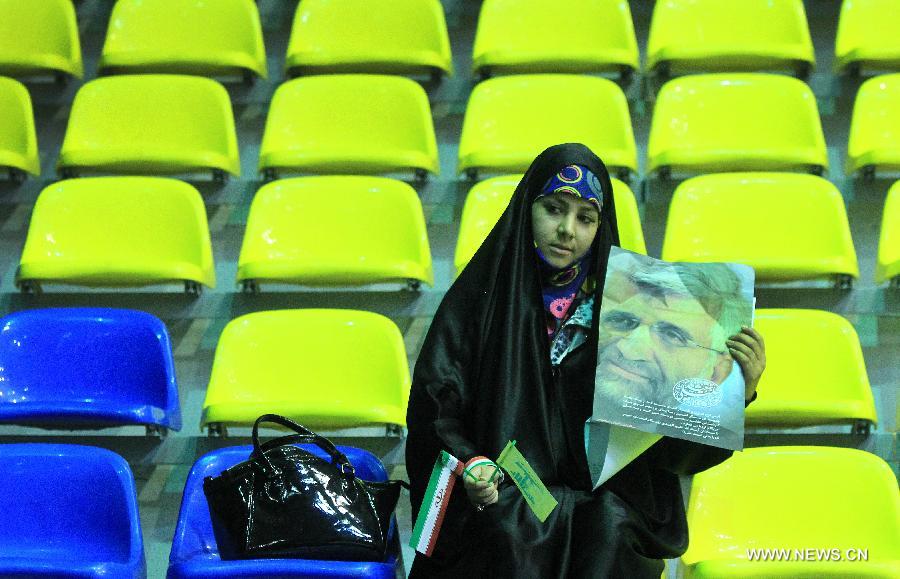 A woman holds up a poster of Iran's chief nuclear negotiator and presidential candidate Saeed Jalili during a campaign rally in downtown Tehran, Iran, on May 24, 2013. Iran's Guardian Council of Constitution announced the names of eight eligible candidates for the upcoming presidential election while barring two major political figures from running for presidency. (Xinhua/Ahmad Halabisaz) 